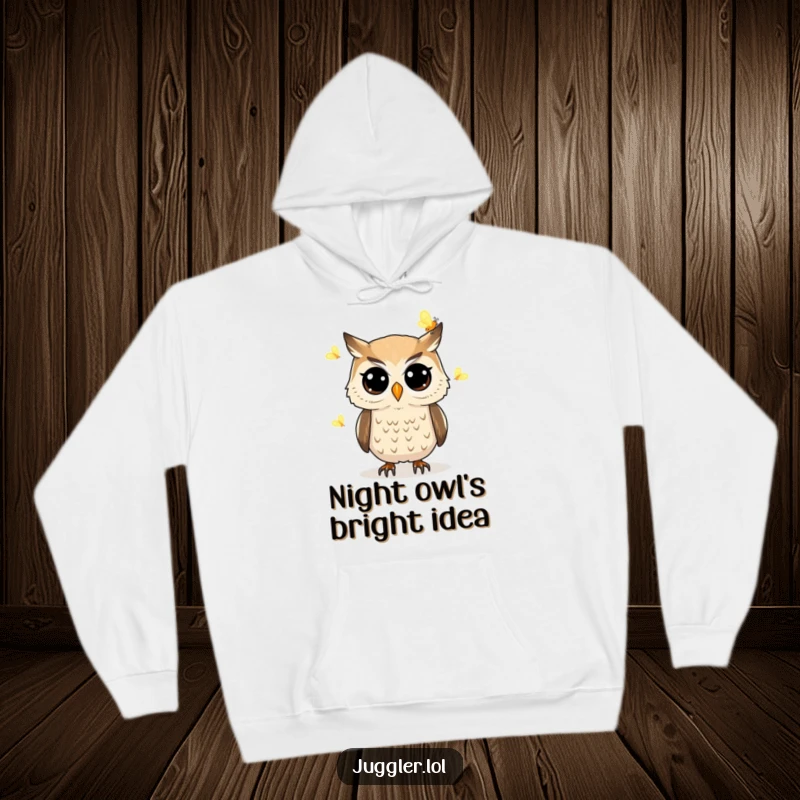Funny owl hoodie showing a determined owl with wide eyes juggling glowing fireflies, perfect for cozy nights and magical moments.