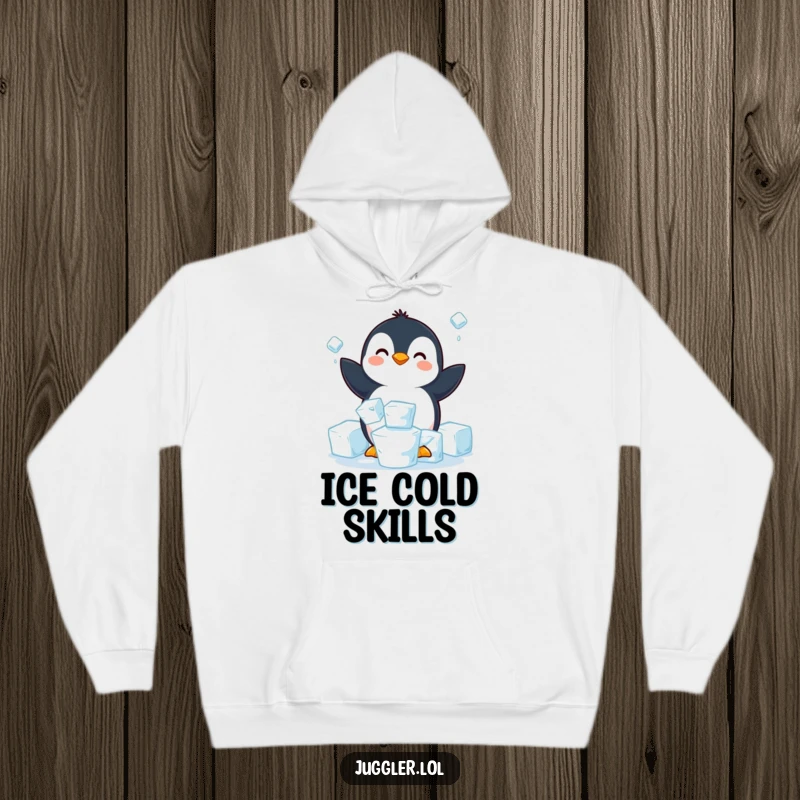 Funny penguin hoodie showing a happy penguin struggling to juggle three slippery ice cubes, perfect for staying warm and amused.